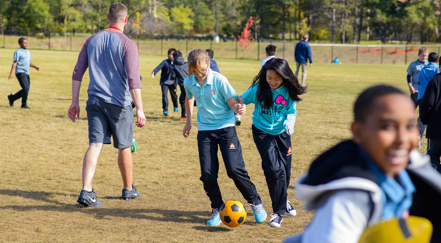 image of two girls playing soccer